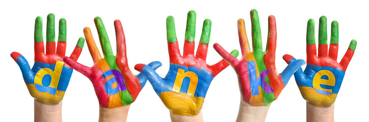 Child's hands in paint making word DANKE (German for Thank you) on white background