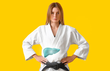 Female karate instructor with healthy liver on yellow background