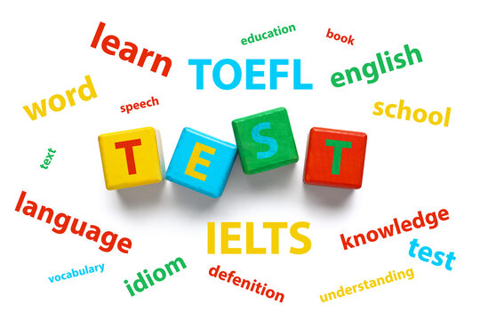 Text TEST made of wooden cubes and different words on white background. Concept of studying English