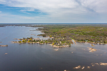 Georigian bay  drone photos with beaches and islands  by waubaushene beach going into lake huron with clouds and blue skies 