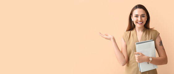 Beautiful young businesswoman holding documents on beige background with space for text