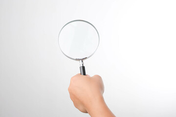Female hand with magnifying glass. Woman holding magnifying glass on white background, close up.