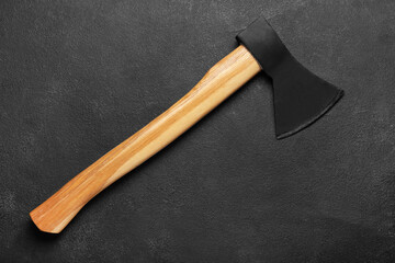 Sharp ax with wooden handle on dark background