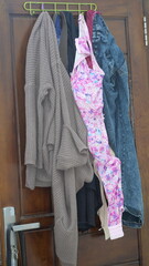 Used clothes hanging on clotheslines