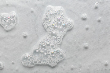 Water with soap foam on grey background