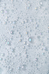Water with soap foam on grey background
