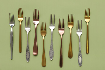 Many different forks on green background
