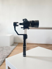 modern camera equipment, black stabilizer tripod with video cinema camera