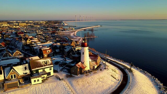 Urk Flevoland Netherlands, a sunny spring day at the old village of Urk with fishing boats at the harbor. Urk harbor. Urk Lighthouse at the lake Ijselmeer