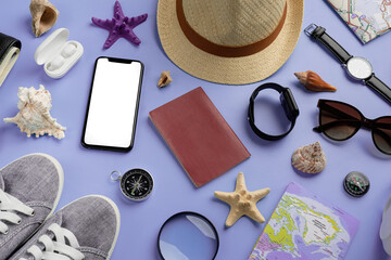 Top view travel accessories with shoes, map, smartphone with mockup screen, hat on very peri purple background