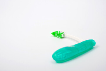 Folding plastic toothbrush for travel and tourism, shot on a white background.