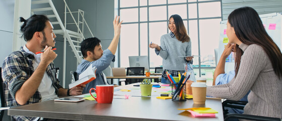 Businesswoman presenting business plan information to team at office meeting, Asian leader woman...
