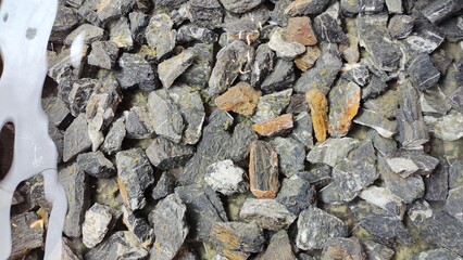 Beautiful mineral stones bathed in crystal clear water with water reflection, detail and close-up
