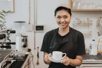 Asian woman barista giving takeout meal to customers. female barista working in coffee shop. Coffee owner concept.