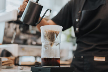 Barista making coffee by pour over in coffee shop.. Close up of hands barista to making a drip coffee. Coffee shop concept