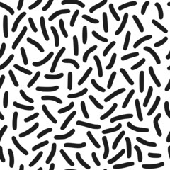 Seamless pattern. Black dashes in chaotic order on a white background.