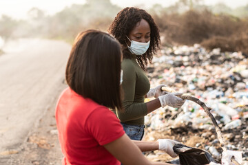 black women cleaning up a dump site