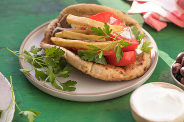 Greek chicken souvlaki ona pita with fresh vegetables with tzatziki sauce