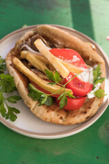 Greek chicken souvlaki ona pita with fresh vegetables with tzatziki sauce