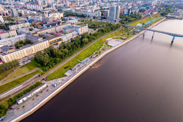 Obraz premium Aerial top view panorama city Perm and central embankment of Kama river Russia, sunset drone photo