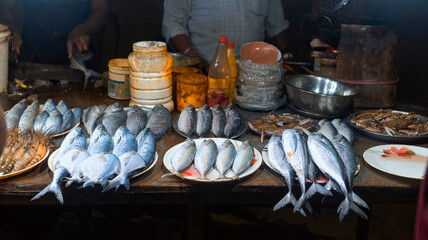variety of fresh sea fishes on display at a fish fry stall (snack food), before they are deep fried...