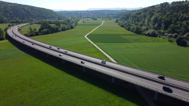 Aerial footage (steady shot) of highway (Autobahn) and cars in rural landscape in the morning light