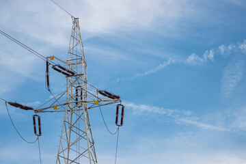 High voltage electric pole with wires on blue sky background. Line of electricity transmissions