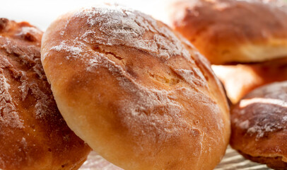 Homemade, fresh round-shaped buns with a crispy brown crust. Close-up. Background.