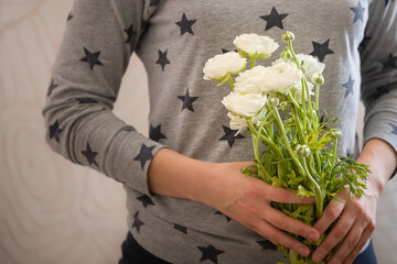 Closeup of Girl with bouquet of Ranunculus flowers