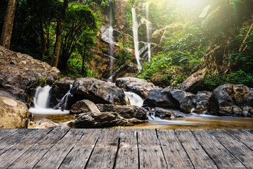 Wooden Table Against Waterfall background.