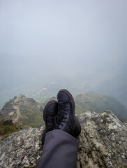 hiker foot resting at mountain top from flat angle at morning