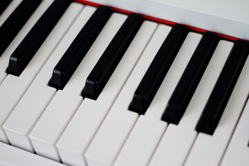 Closeup of piano keyboard with glossy black and white keys as a music background