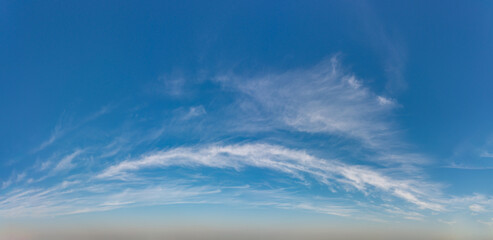 Fantastic clouds against blue sky, panorama