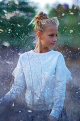 Portrait of a girl among the dry wind in the autumn evening