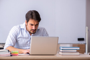 Young male teacher in telestudying concept