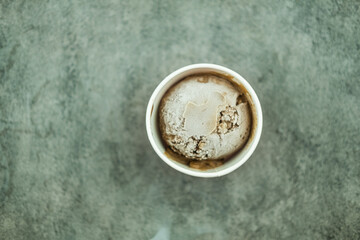 Chocolate flavor ice cream scoops or balls in cardboard cup packaging