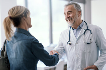 Doctor greeting a patient in his office