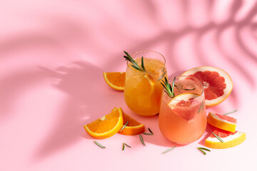 Summer cocktails with grapefruit, orange, rosemary, and ice. - obrazy, fototapety, plakaty