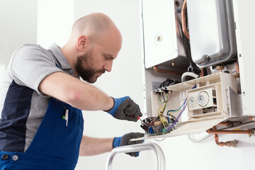 Qualified engineer servicing a boiler