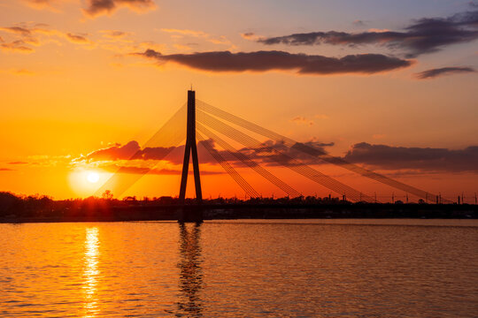 picturecque view from water surface to large river and cable - stayed bridge
