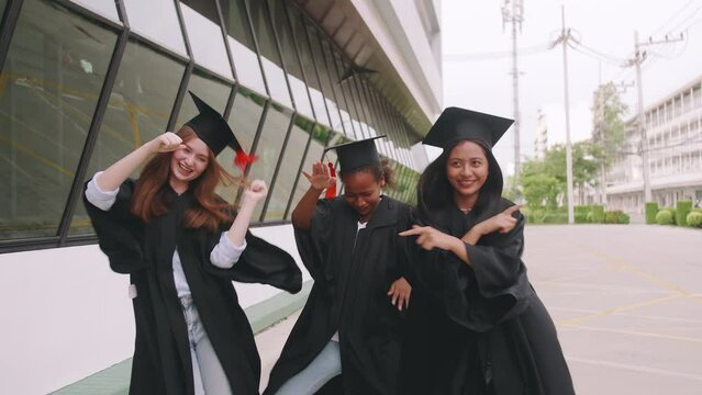 Group of friends having fun celebrating their graduation by dancing together.