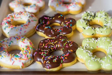 Tasty donuts with jam on wooden background - Hanukkah celebration concept
