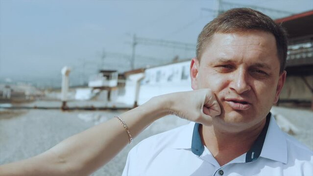 A girl in slow motion strikes a man in the face with her hand