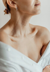 Close-up of a young woman's neck, collarbone, chest. Lines on the neck. Wrinkles, age-related...