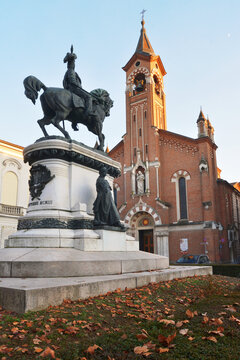 Asti, Piedmont, Italy - The equestrian monument of Umberto I of Savoy and church of Saint Joseph on background