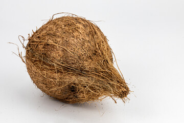 Dried coconut with extreme details of its body texture and hair, isolated in black background and in white background, studio lighting, standing tall and lying down, different angles and composition. 