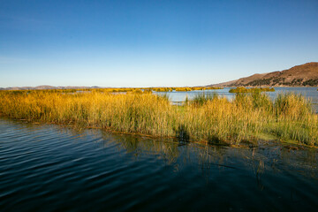 The floating village of Uros on Lake Titicaca, Peru. Lake Titicaca is the largest lake in South America and the highest navigable lake in the world.