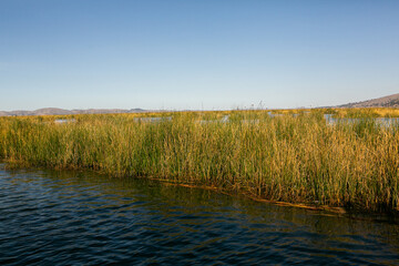 The floating village of Uros on Lake Titicaca, Peru. Lake Titicaca is the largest lake in South America and the highest navigable lake in the world.