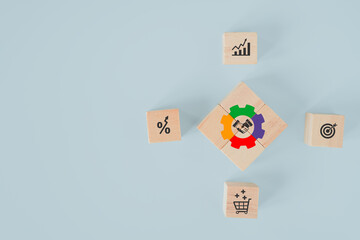 arranged wooden cube blocks with multi color of gear icon with shake hand icon inside on blue background,  for key to success, cooperation, marketing and team work concept