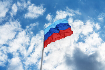 Flag of the self-proclaimed Lugansk People's Republic (LPR or LNR) is waving in front of blue sky...